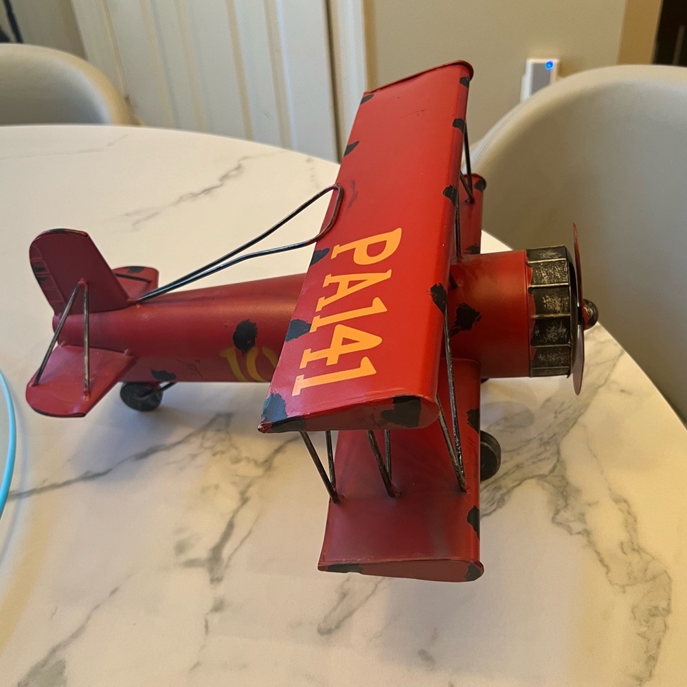 Red industrial model airplane decor.